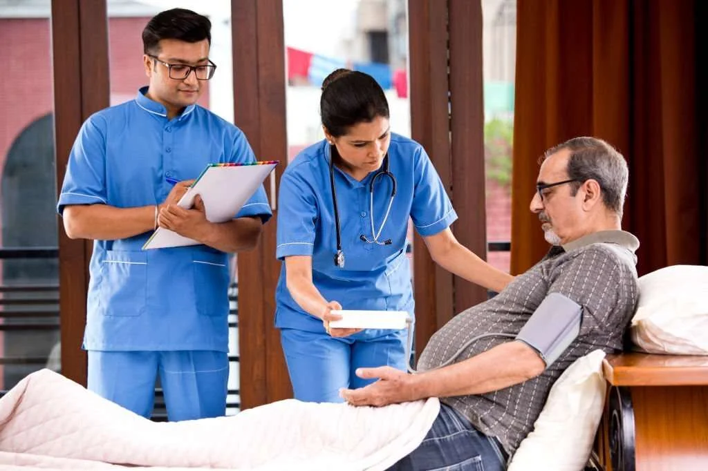 Senior Caregiver Assisting Elderly Person